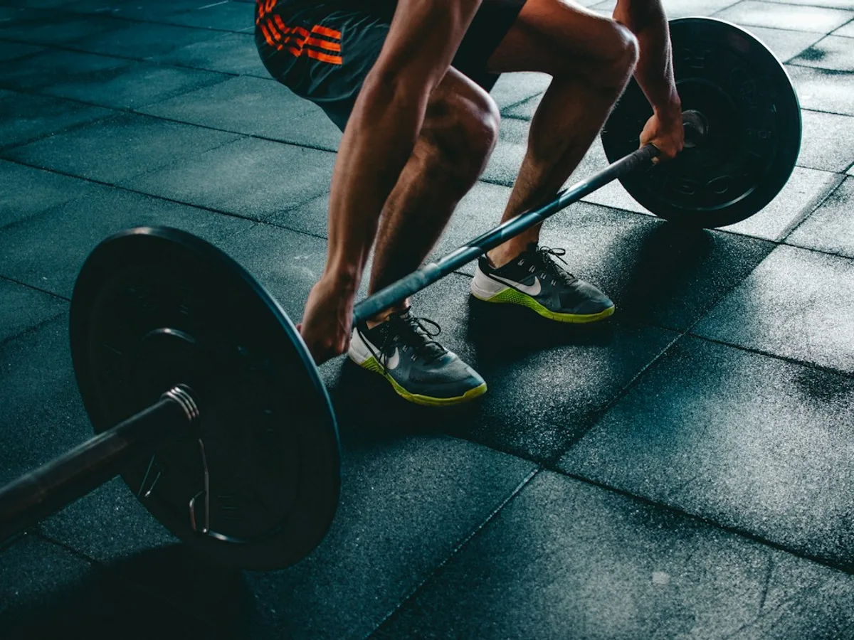 Athlete training with a dumbbell in a gym
